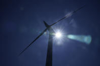 A wind turbine works on the campus of Massachusetts Maritime Academy in Bourne, Mass., Wednesday, Aug. 3, 2022. The U.S. has renewed legitimacy on global climate issues and will be able to inspire other nations in their own emissions-reducing efforts, experts said, after the Democrats pushed their big economic bill through the Senate on Sunday, Aug. 7. (AP Photo/Seth Wenig)