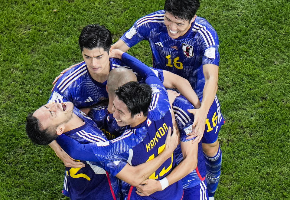 Japan's Daizen Maeda celebrates with his teammates after scoring his side's opening goal during the World Cup round of 16 soccer match between Japan and Croatia at the Al Janoub Stadium in Al Wakrah, Qatar, Monday, Dec. 5, 2022. (AP Photo/Hassan Ammar)