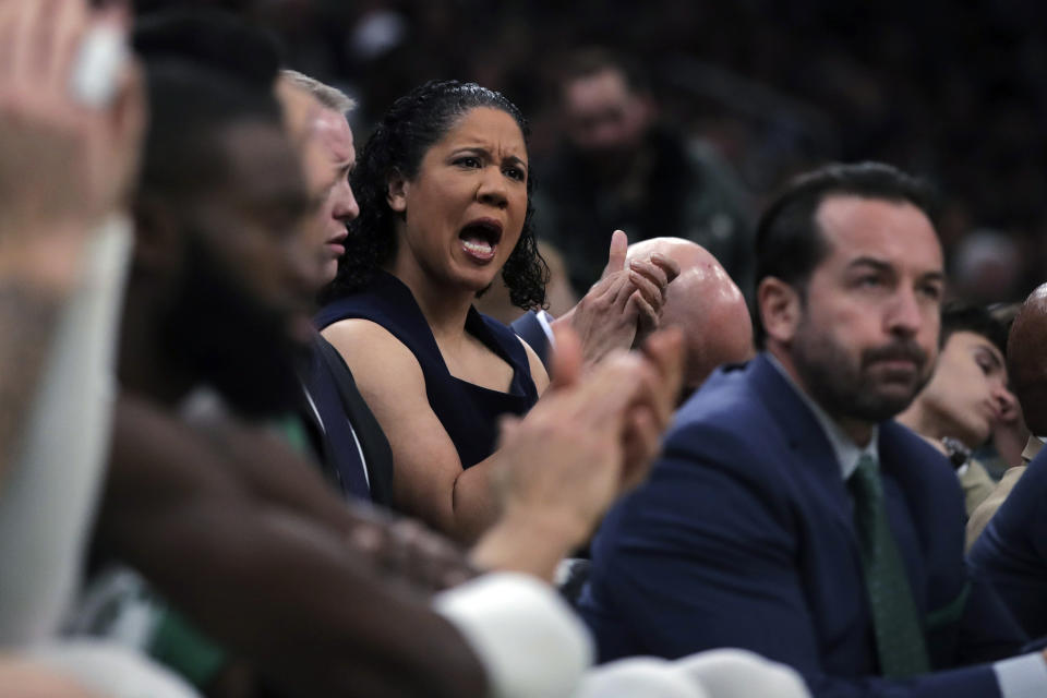 Boston Celtics assistant coach Kara Lawson applauds after a 3-point shot by Jaylen Brown during the second half of an NBA basketball game against the Miami Heat in Boston, Wednesday, Dec. 4, 2019. (AP Photo/Charles Krupa)