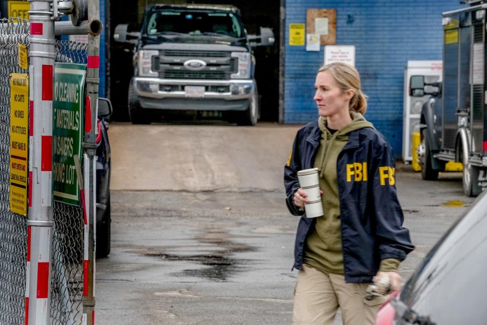 A law-enforcement vehicle in the bay of Accurate Converter. FBI agents and police officers removed boxes Thursday from the business off Branch Avenue in Providence.