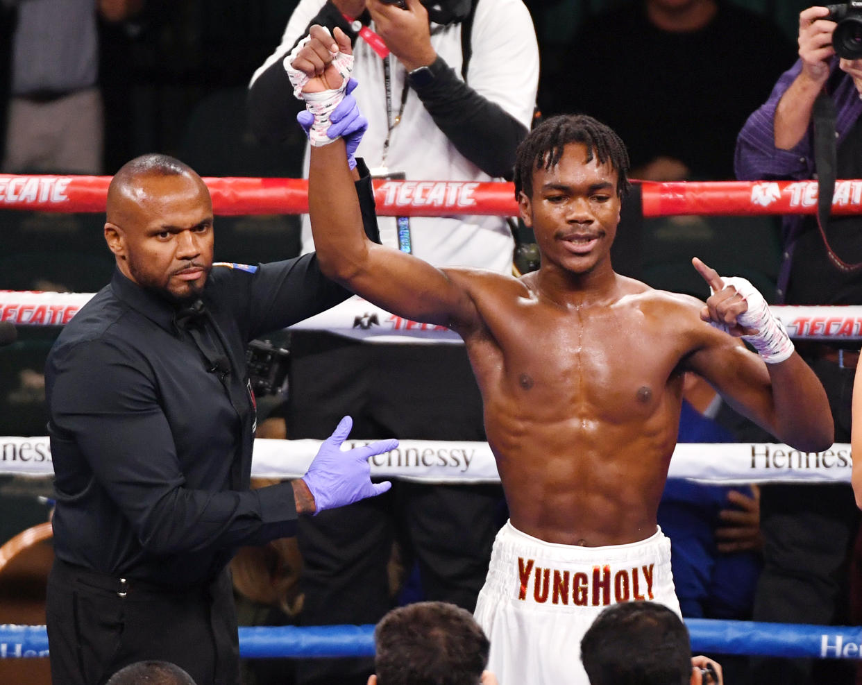 LAS VEGAS, NEVADA - NOVEMBER 02:  Referee Robert Hoyle holds up the arm of Evan Holyfield as he celebrates his first-round TKO victory over  Nick Winstead 16 seconds into their welterweight bout at MGM Grand Garden Arena on November 2, 2019 in Las Vegas, Nevada.  (Photo by Ethan Miller/Getty Images)