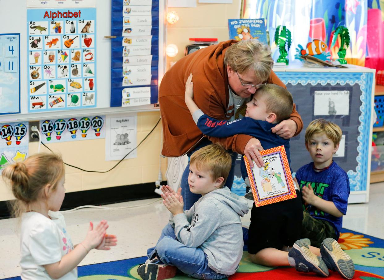 Humansville school employee Becky Peters hugs her grandson Hudson after reading to his preschool class Nov. 15.