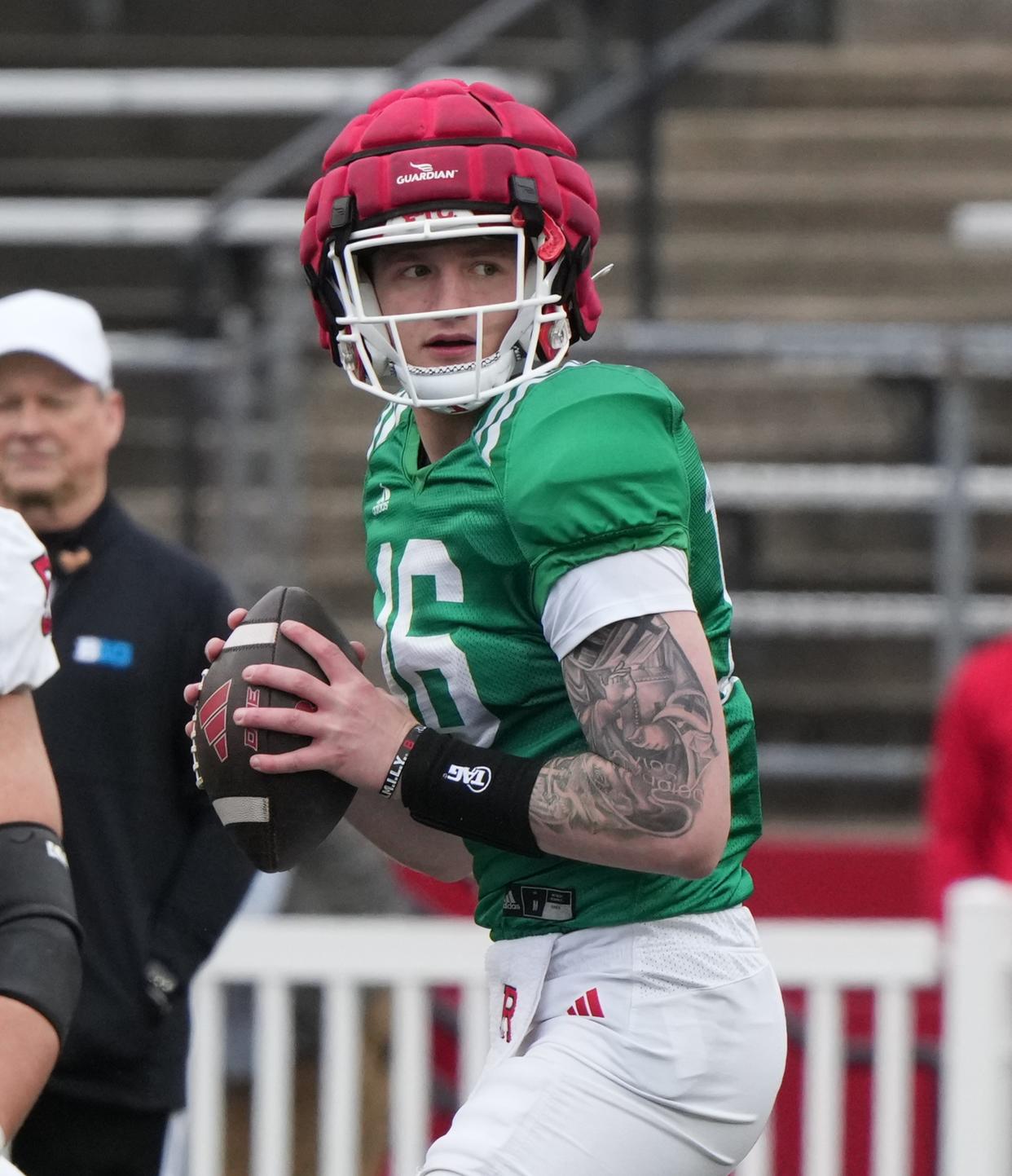 Piscataway, NJ -- April 27, 2024 -- Coach Greg Schiano and quarterback, Athan Kaliakmanis during Rutgers annual spring football game at SHI Stadium.