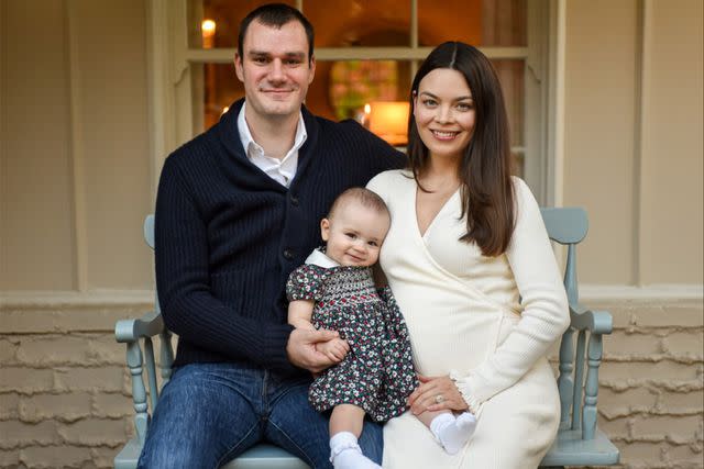 cooper hefner/ instagram Cooper Hefner, Scarlett Byrne Hefner and their daughter Betsy pose for a portrait on a chair.