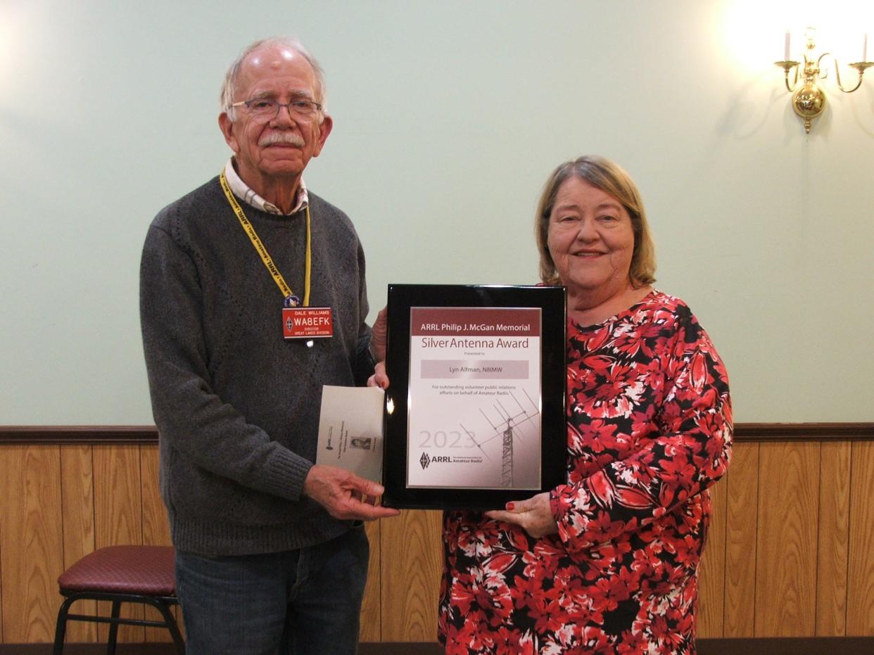 Cambridge Amateur Radio Association Public Information Officer Lyn Alfman receives the Philip J. McGan Memorial Silver Antenna Award by ARRL Great Lakes Division Director Dale Williams of Dundee, Michigan at CARA’s 110th anniversary awards banquet. The annual award is given nationally to a public information officer who promotes every aspect of amateur radio. Alfman has been CARA’s public information officer for 24 years and an ARRL Ohio section public information officer for 12 years.