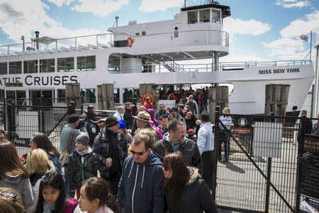 Passengers disembark from a Statue of Liberty Island ferry boat in lower Manhattan in New York April 24, 2015. REUTERS/Lucas Jackson