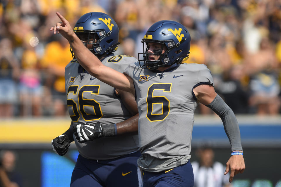 West Virginia quarterback Garrett Greene (6) reacts after a play against Towson during the first half of an NCAA college football game in Morgantown, W.Va., Saturday, Sept. 17, 2022. (AP Photo/William Wotring)