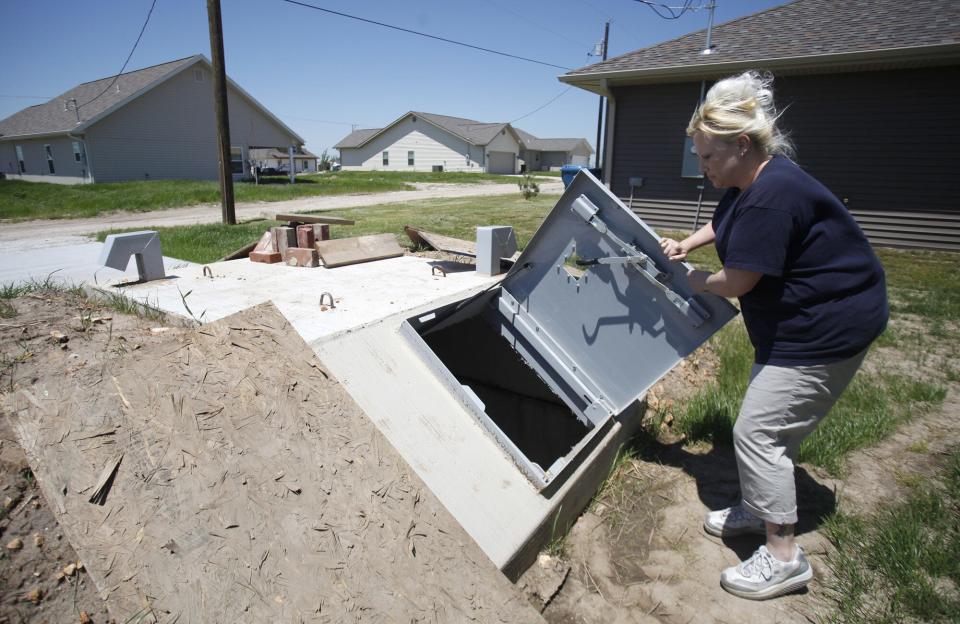 Tracy Anderson opens her storm shelter on May 14, 2013 that she had installed behind her new house in Joplin, Mo. Her home was destroyed in the May 22, 2011, tornado that ravaged Joplin.