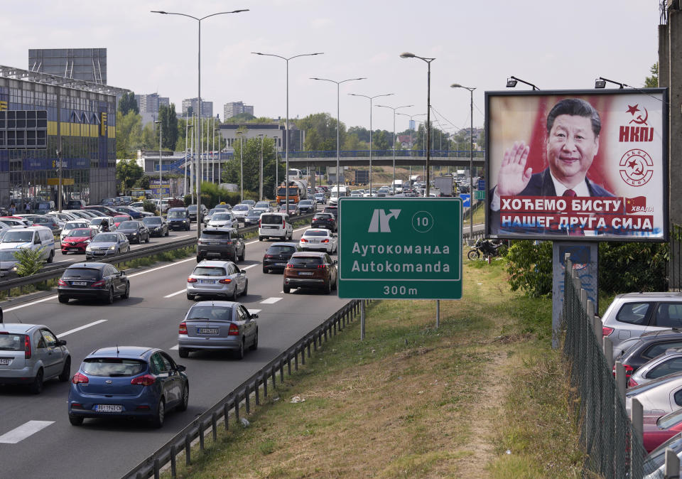 FILE - Cars move by a billboard showing China's President Xi Jinping, reading: "We want a statue of our friend Xi," and "Thanks," in Belgrade, Serbia, on Aug. 26, 2021. Chinese leader Xi Jinping's visit to European ally Serbia on Tuesday, May 7, 2024, falls on a symbolic date: the 25th anniversary of the bombing of the Chinese Embassy in Belgrade during NATO's air war over Kosovo. (AP Photo/Darko Vojinovic, File)