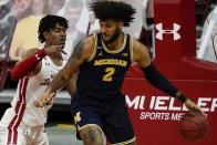 Wisconsin's Aleem Ford defends Michigan's Isaiah Livers during the first half of an NCAA college basketball game Sunday, Feb. 14, 2021, in Madison, Wis. (AP Photo/Morry Gash)