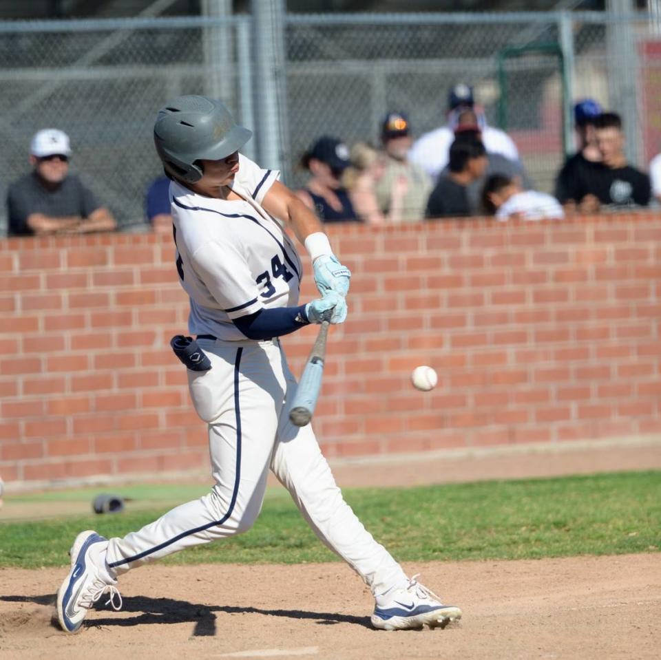 Central Catholic’s Adrian Garcia makes contact with a pitch during Game 1 of the CIF Sac-Joaquin Section D-III semifinals against Oakdale at Oakdale High School on Monday, May 13, 2024. Central Catholic took a 1-0 series lead with an 8-1 win.