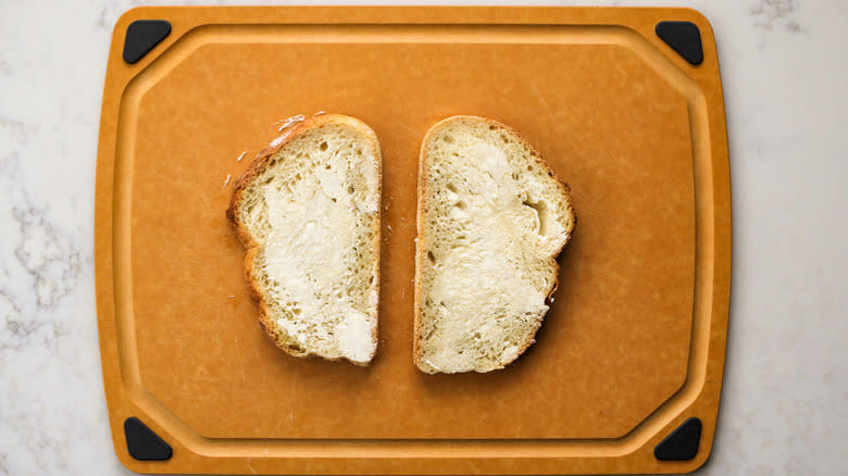 buttered bread slices on cutting board