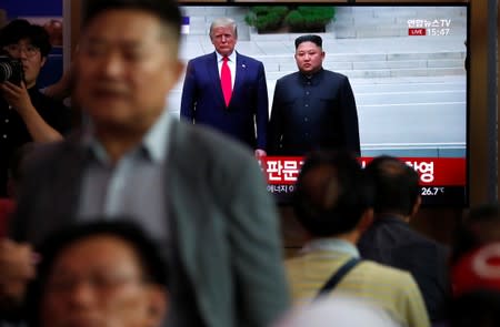 South Korean people watch a live TV broadcast on a meeting between North Korean leader Kim Jong Un and U.S. President Donald Trump at the truce village of Panmunjom inside the demilitarised zone separating the two Koreas, in Seoul