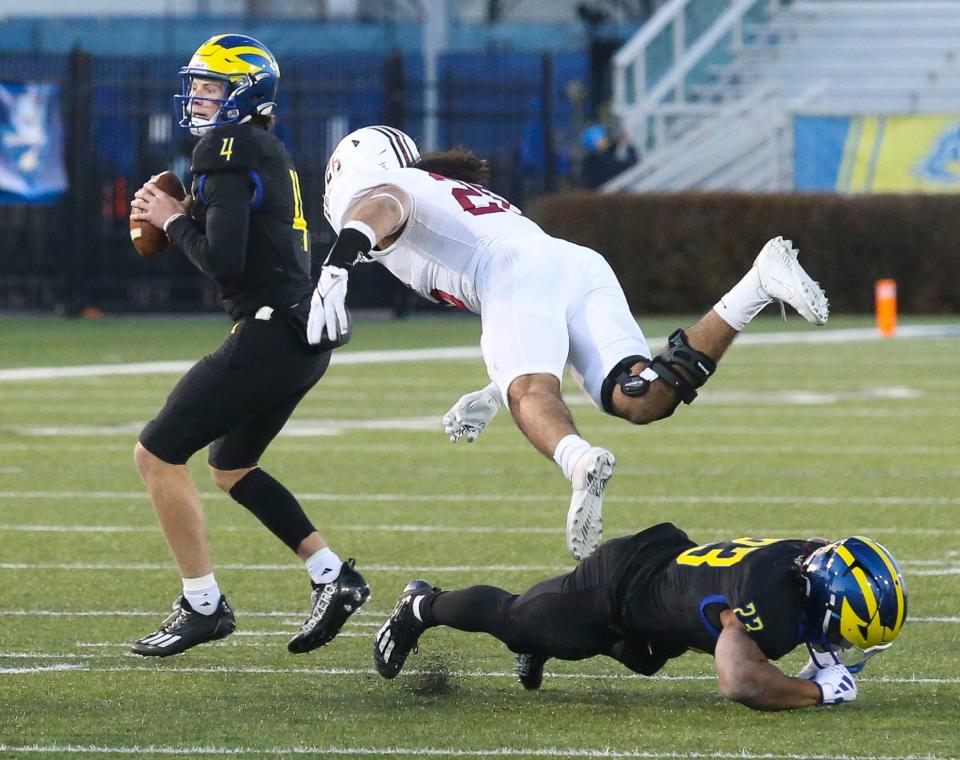 Delaware quarterback Nick Minicucci waits before throwing a fourth quarter touchdown pass as Quincy Watson slows Lafayette's Marco Olivas with a block in the Blue Hens' 36-34 comeback win in the opening round of the NCAA FCS playoffs Saturday, Nov. 25, 2023 at Delaware Stadium.