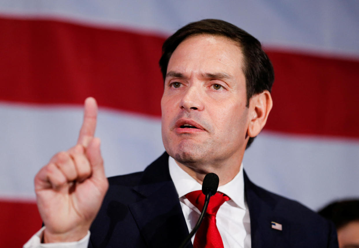 Sen. Marco Rubio points his index finger upward.