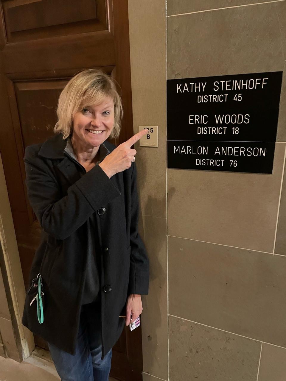 State Rep. Kathy Steinhoff points to her name at the Missouri State Capitol indicating her new office.