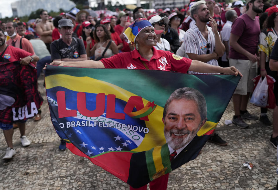 A supporter of Luiz Inacio Lula da Silva displays a banner during his inauguration as new president outside the Planalto presidential palace in Brasilia, Brazil, Sunday, Jan. 1, 2023. (AP Photo/Silvia Izquierdo)