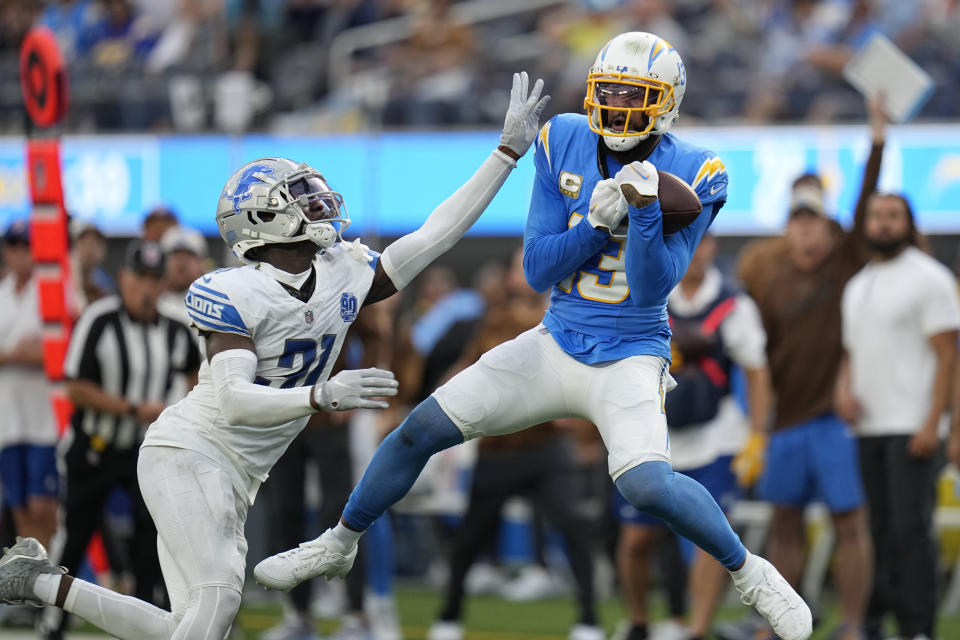 Los Angeles Chargers wide receiver Keenan Allen (13) makes a catch next to Detroit Lions safety Kerby Joseph (31) during the first half an NFL football game Sunday, Nov. 12, 2023, in Inglewood, Calif. (AP Photo/Gregory Bull)