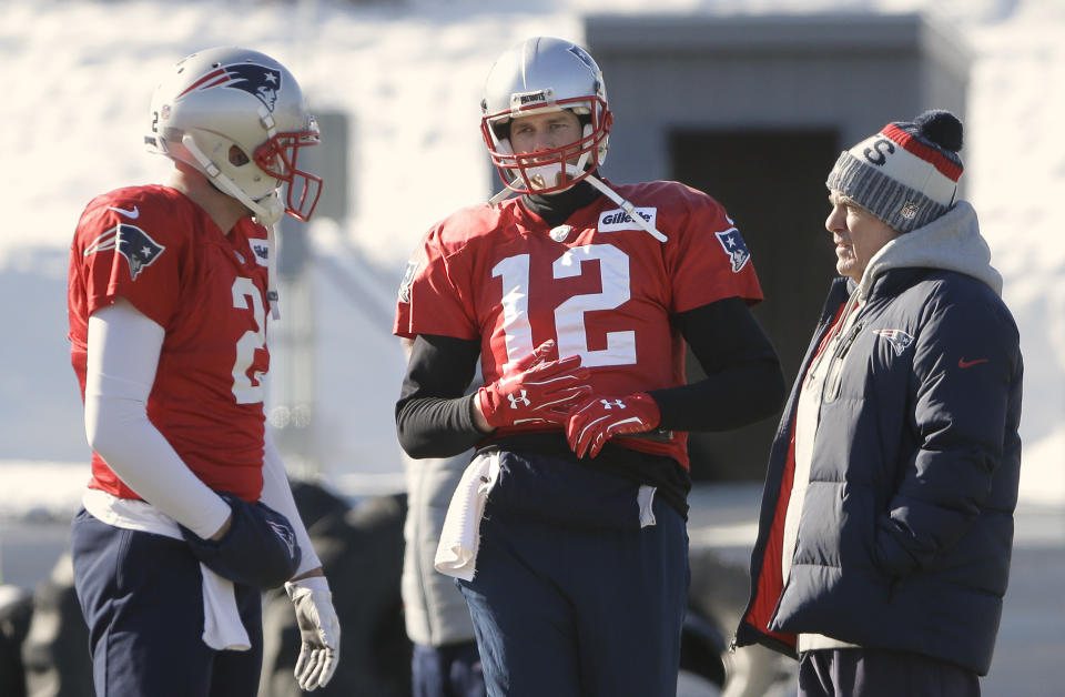 Tom Brady (12) wears gloves at practice Thursday after hurting his right hand on Wednesday. (AP)