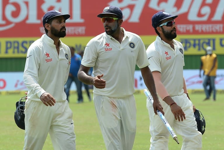 India's Ravichandran Ashwin (centre) is the second-fastest bowler of all time to reach 200 Test wickets