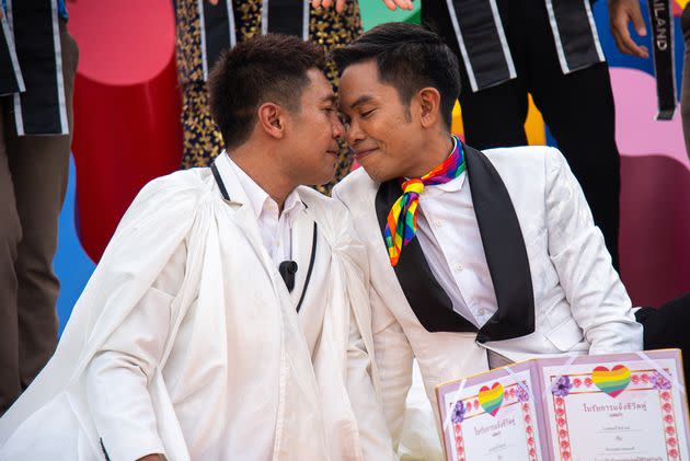 A Thai couple poses for a photo during the celebration event at the Government house. 