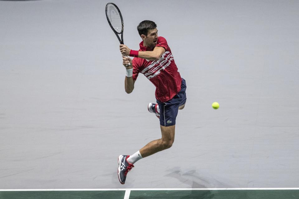 Serbia's Novak Djokovic returns the ball to Russia's Karen Khachanov during their Davis Cup tennis match in Madrid, Spain, Friday, Nov. 22, 2019. (AP Photo/Bernat Armangue)