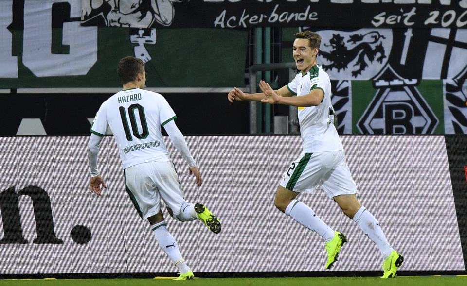 Moenchengladbach's Florian Neuhaus, right, celebrates with Moenchengladbach's Thorgan Hazard after he scored his side's second goal during the German Bundesliga soccer match between Borussia Moenchengladbach and VfB Stuttgart in Moenchengladbach, Germany, Sunday, Dec. 9, 2018. (AP Photo/Martin Meissner)