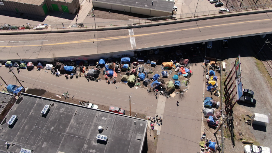 Aerial view of tent encampment beside overpass