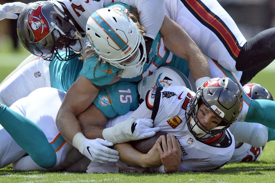 Miami Dolphins outside linebacker Andrew Van Ginkel (43) and outside linebacker Jaelan Phillips (15) team up to sack Tampa Bay Buccaneers quarterback Tom Brady (12) during the first half of an NFL football game Sunday, Oct. 10, 2021, in Tampa, Fla. (AP Photo/Jason Behnken)