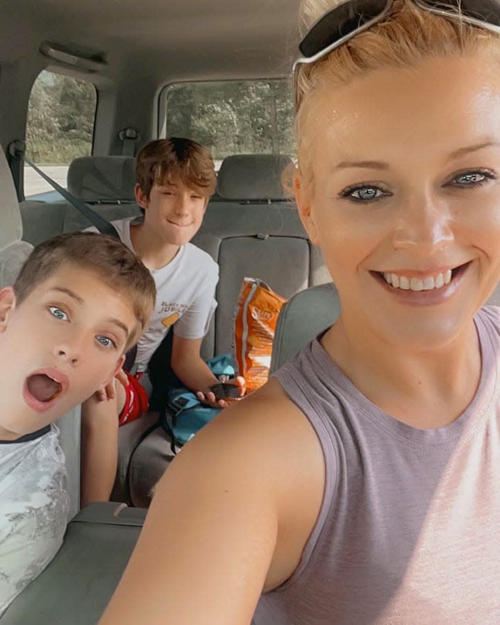 Brittney Schuit tales a selfie with sons Austin and Jayden Schuit in the car bought by Brittney through Working Wheels.