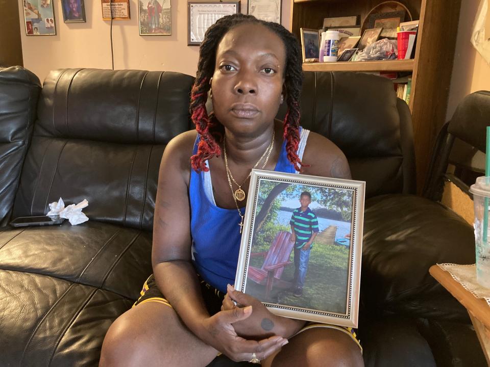 Stephanie Smith, 39, on July 20, 2023, holds an early photo of her son, 16-year-old Vontreaz Banner, who died after being shot July 17, 2023, in St. Lucie County.