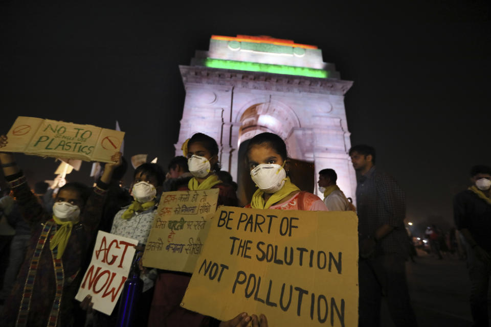 Children wear masks and hold placards during a protest against the alarming levels of pollution in the city, near the India Gate monument in New Delhi, India, Tuesday, Nov. 5, 2019. The 20 million residents of New Delhi, already one of the world's most polluted cities, have been suffering for weeks under a toxic haze that is up to 10 times worse than the upper limits of what is considered healthy. The pollution crisis is piling public pressure on the government to tackle the root causes of the persistent haze. (AP Photo/Manish Swarup)