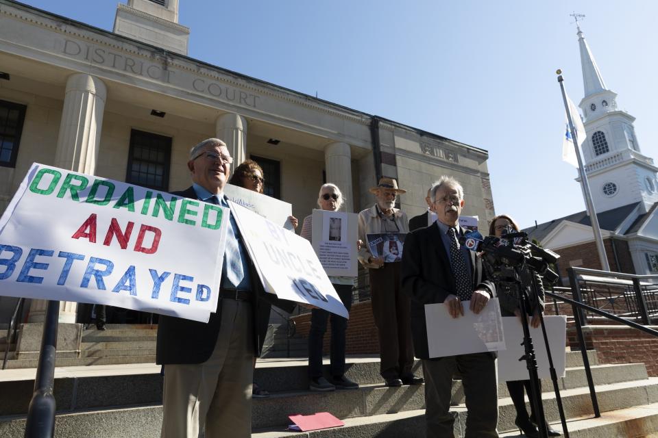 Members of BishopAccountability.org hold a news conference outside Dedham District Court following the arraignment of former Cardinal Theodore McCarrick, Friday, Sept. 3, 2021, in Dedham, Mass. McCarrick has pleaded not guilty to sexually assaulting a 16-year-old boy during a wedding reception in Massachusetts nearly 50 years ago. (AP Photo/Michael Dwyer)