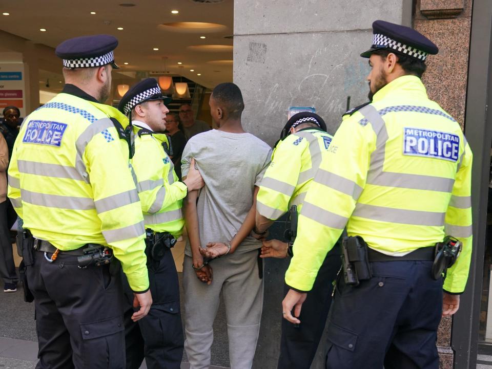 A person is detained outside McDonald's on Oxford Street, central London. Picture date: Wednesday August 9, 2023.