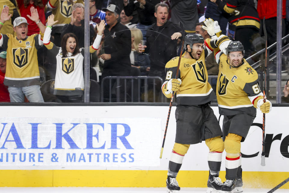 Vegas Golden Knights left wing William Carrier (28) and Vegas Golden Knights right wing Mark Stone (61) react after Carrier's goal against the Colorado Avalanche during the second period of an NHL hockey game Saturday, Nov. 4, 2023, in Las Vegas. (AP Photo/Ian Maule)