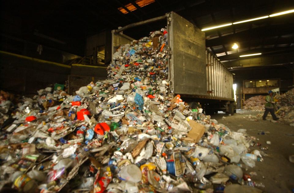 When a recycle truck arrives at the Republic Services of Indiana, its driver has to unload all the recyclable trash to the floor. All kind of trash will be placed on a belt before sending to its sorting house.