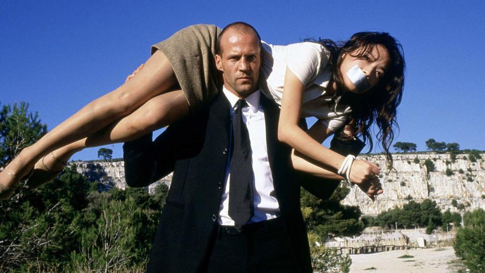 Jason Statham carries Shu Qi on his shoulders in The Transporter