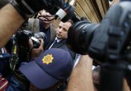 Oscar Pistorius leaves court after the second day of the trial of the Olympic and Paralympic track star at the North Gauteng High Court in Pretoria, March 4, 2014. REUTERS/Mike Hutchings (SOUTH AFRICA - Tags: SPORT ATHLETICS ENTERTAINMENT CRIME LAW)