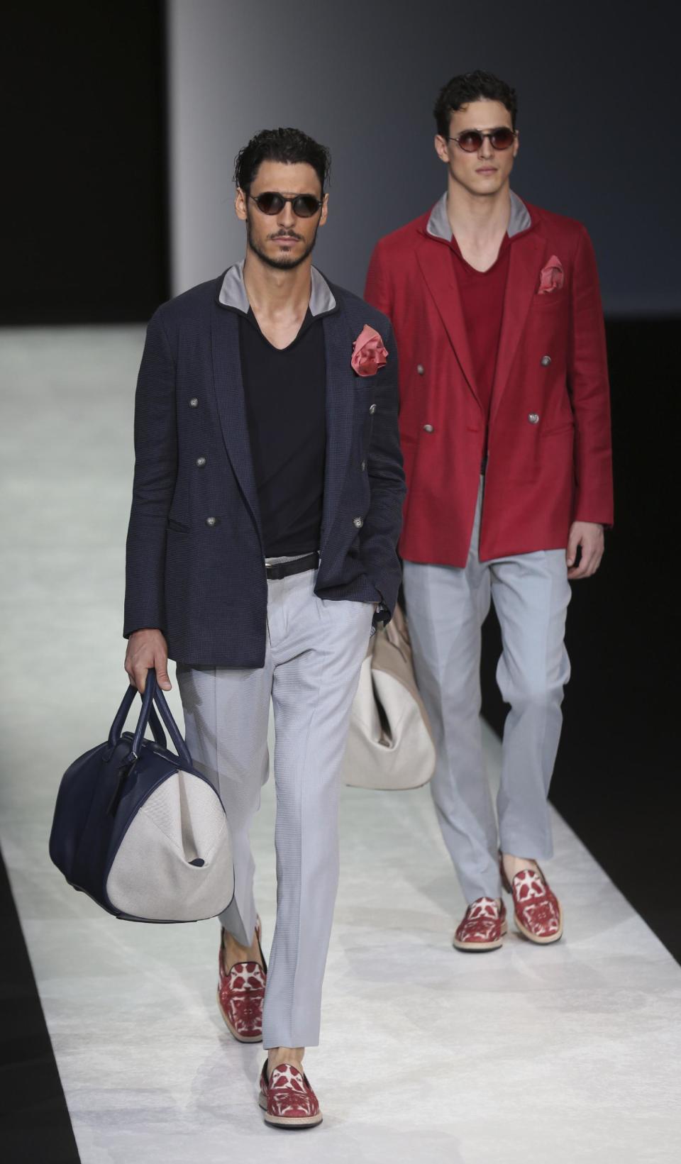 Models wear creations for Giorgio Armani men's Spring-Summer 2014 collection, part of the Milan Fashion Week, unveiled in Milan, Italy, Tuesday, June 25, 2013. (AP Photo/Luca Bruno)