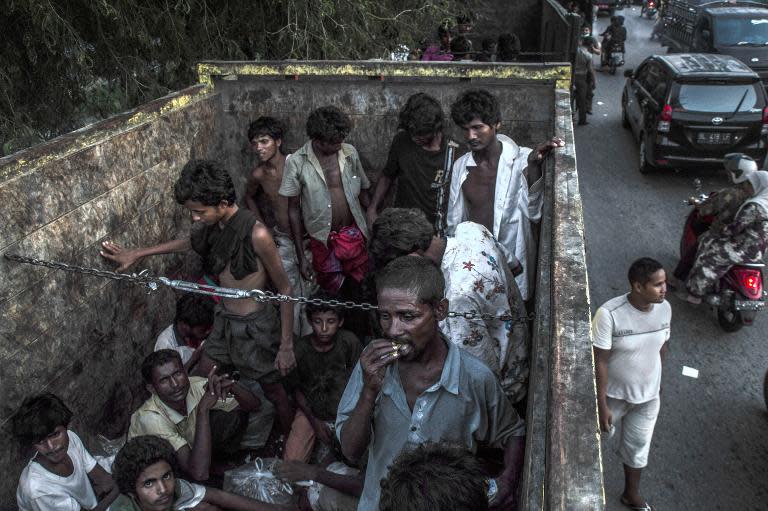 Rohingya men from Myanmar are transported on a truck to a confinement area in Bayeun, Indonesia, on May 21, 2015, after hundreds of migrants were rescued by fishermen off the coast of Aceh province