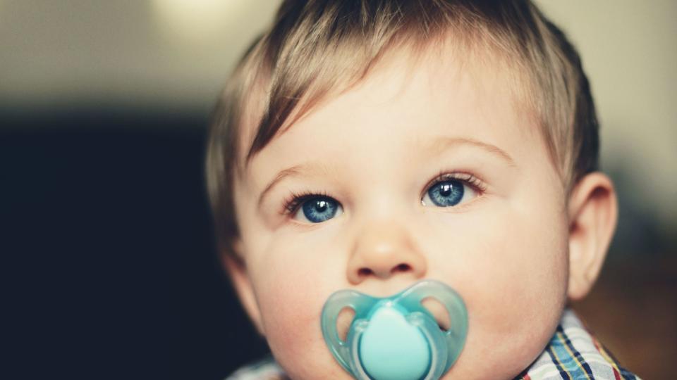 baby boy with pacifier in his mouth, portrait