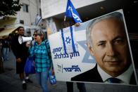 Supporters of Israeli Prime Minister Benjamin Netanyahu protest outside Likud Party headquarters in Tel Aviv