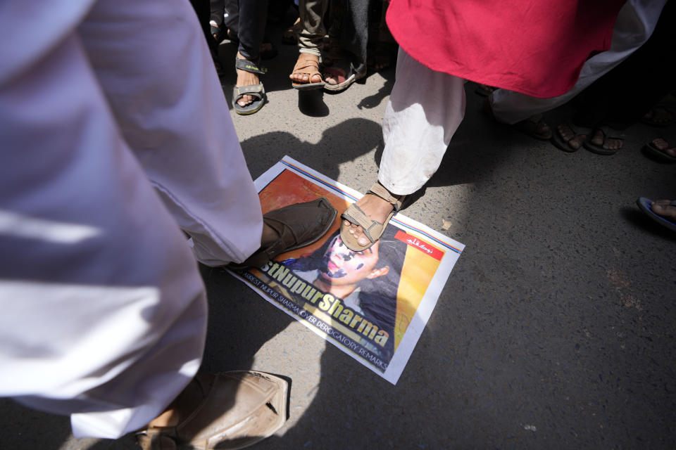 Indian Muslims stamp on a photo of Nupur Sharma, a spokesperson of governing Hindu nationalist party as they react to the derogatory references to Islam and the Prophet Muhammad made by her, during a protest in Ahmedabad, India, Friday, June 10, 2022. At least five Arab nations have lodged official protests against India, and Pakistan and Afghanistan also reacted strongly Monday to the comments made by two prominent spokespeople from Prime Minister Narendra Modi's Bharatiya Janata Party. (AP Photo/Ajit Solanki)