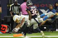 Los Angeles Chargers running back Austin Ekeler (30) dives for a touchdown past Houston Texans safety Jonathan Owens (36) during the second half of an NFL football game Sunday, Oct. 2, 2022, in Houston. (AP Photo/David J. Phillip)