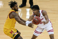 Wisconsin's Aleem Ford (2) passes the ball as Maryland's Donta Scott defends during the first half of an NCAA college basketball game Tuesday, Jan. 14, 2020, in Madison, Wis. (AP Photo/Andy Manis)