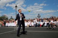 French President Emmanuel Macron plays tennis on the Pont Alexandre III in Paris, France, June 24, 2017. REUTERS/Jean-Paul Pelissier