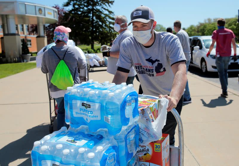 Volunteers unload water and supplies at a centre for residents evacuated from their homes along the Tittabawassee River, after several dams breached, in Midland