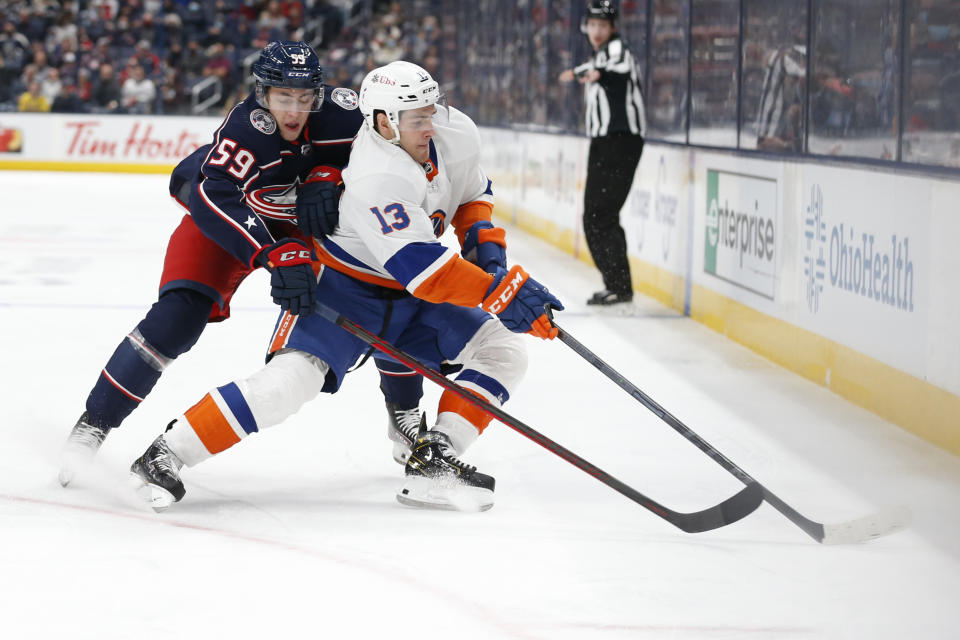 New York Islanders' Mathew Barzal, right, controls the puick as Columbus Blue Jackets' Yegor Chinakhov defends during the first period of an NHL hockey game Thursday, Oct. 21, 2021, in Columbus, Ohio. (AP Photo/Jay LaPrete)