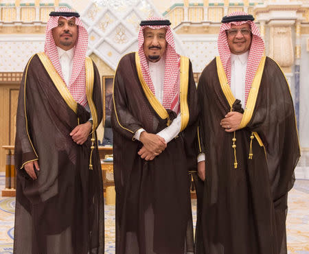 Saudi King Salman bin Abdulaziz Al Saud poses for a photo with National Guard Minister Khaled bin Ayyaf and Economy Minister Mohammed al-Tuwaijri during a swearing-in ceremony in Riyadh, Saudi Arabia, November 6, 2017. Saudi Press Agency/Handout via REUTERS