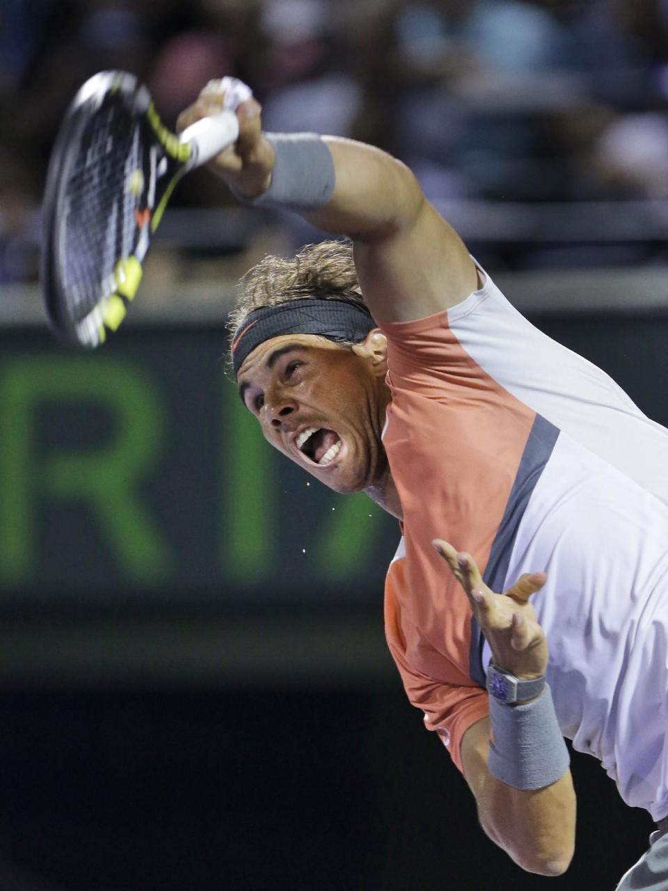 Rafael Nadal, of Spain, serves to Lleyton Hewitt, of Australia, at the Sony Open tennis tournament, Saturday, March 22, 2014, in Key Biscayne, Fla. (AP Photo/Wilfredo Lee)